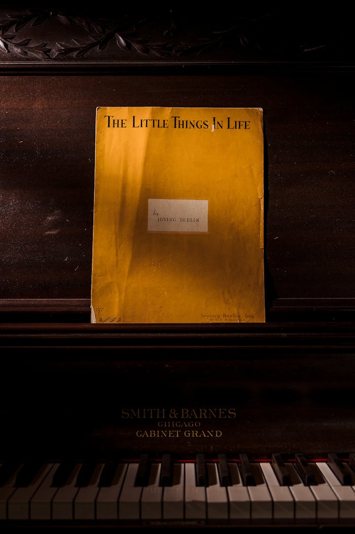 A classic Smith & Barnes piano with a vintage sheet music titled 'The Little Things In Life'.